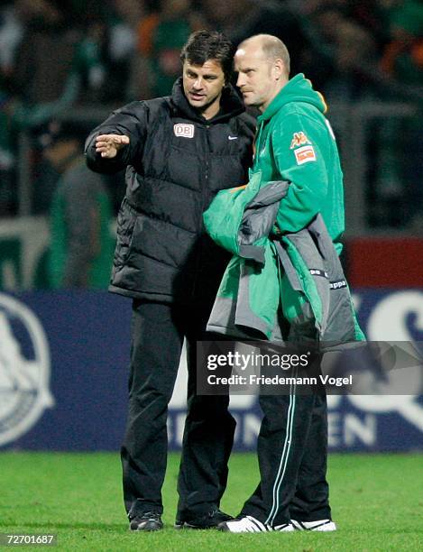 Coach Falko Goetz speaks with Coach Thomas Schaaf of Werder after the Bundesliga match between Werder Bremen and Hertha BSC Berlin at the Weser...
