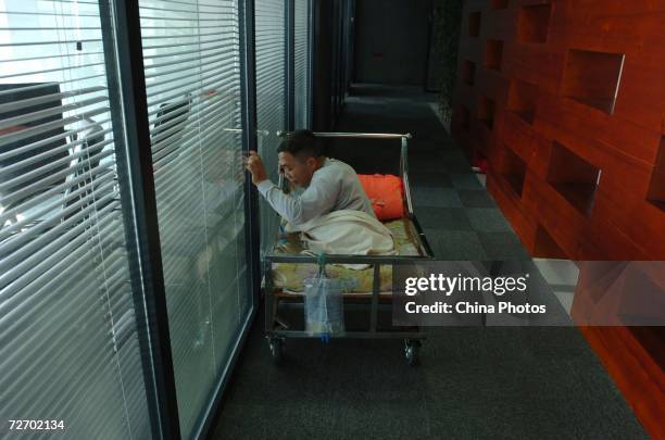 Peng Shuilin exercises his hands December 2, 2006 in Beijing, China. Peng Shuilin was hit by a freight truck in a traffic accident in 2004 and his...