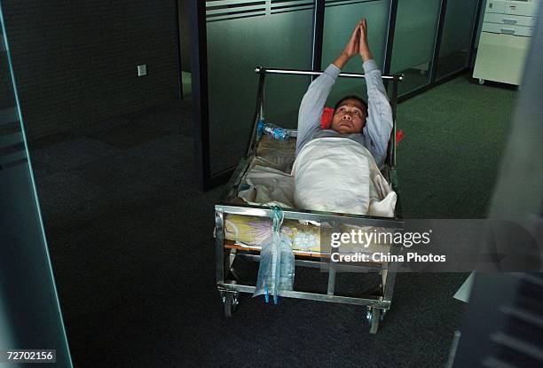 Peng Shuilin exercises his hands December 2, 2006 in Beijing, China. Peng Shuilin was hit by a freight truck in a traffic accident in 2004 and his...