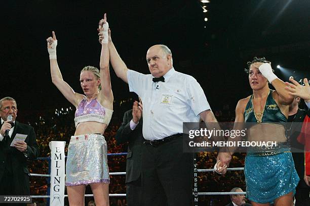 France's Anne-Sophie Mathis waves after winning the WBA Women World Boxing championship in the lightweight category , against her compatriot Myriam...