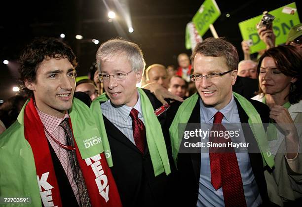 Newly elected Liberal Party Leader Stephane Dion is congratulated by Gerard Kennedy and Justin Trudeau after delivering his victory speech at the...