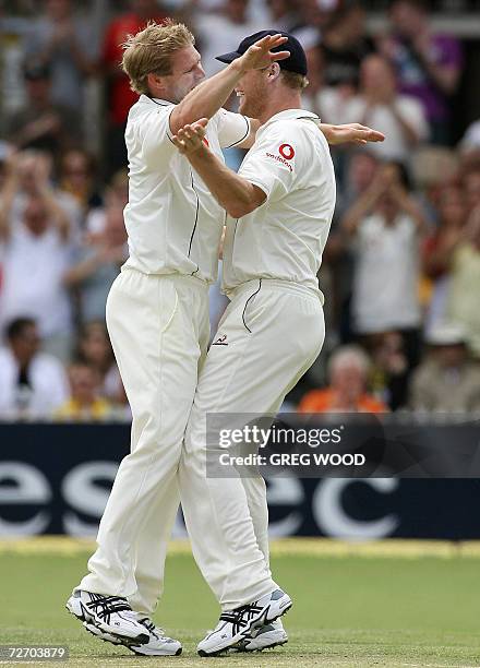 England bowler Matthew Hoggard is congratulated by captain Andrew Flintoff after taking the wicket of Australia's Matthew Hayden on day-three of the...