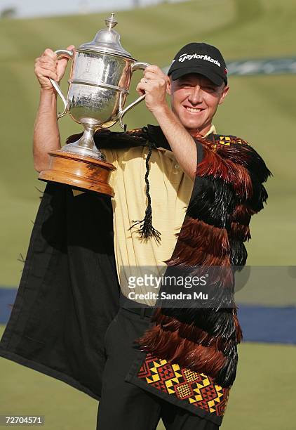 Nathan Green of Australia raises the trophy after winning the New Zealand Open at Gulf Harbour Country Club on the Whangaparoa Peninsula December 3,...