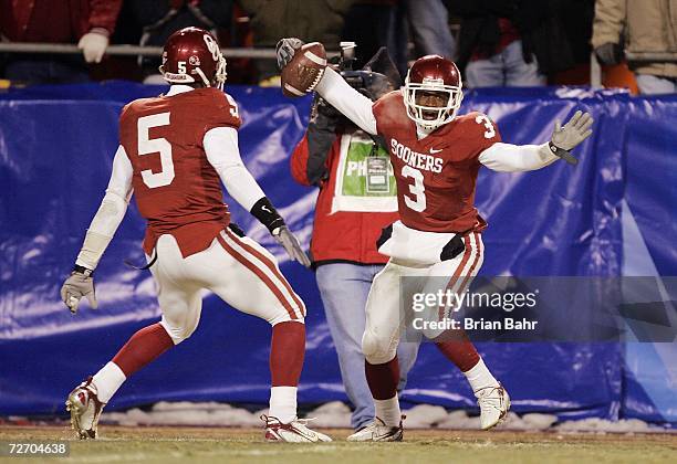 Defensive back Reggie Smith of the Oklahoma Sooners celebrates with Nic Harris after intercepting the Nebraska Cornhuskers late in the fourth quarter...