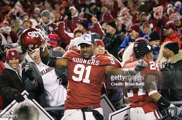 Defensive end Alonzo Dotson of the Oklahoma Sooners celebrates amongst fans after winning the 2006 Dr. Pepper Big 12 Championship against the...