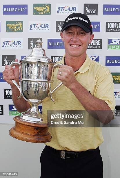 Nathan Green of Australia holds the trophy after winning the New Zealand Open at Gulf Harbour Country Club on the Whangaparoa Peninsula December 3,...