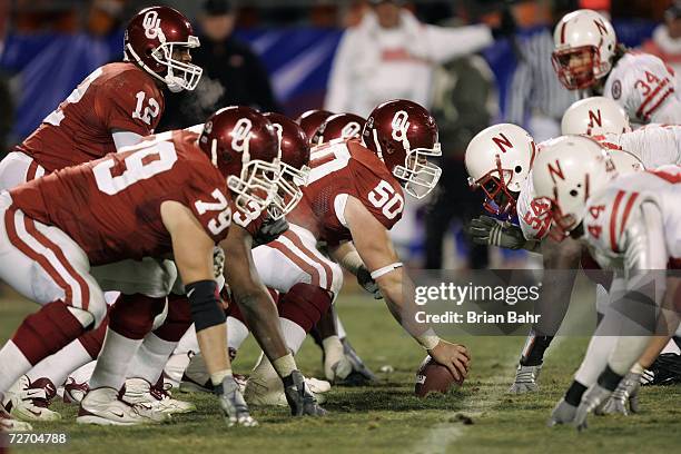 Center Jon Cooper of the Oklahoma Sooners prepares to snap the ball to quarterback Paul Thompson against the Nebraska Cornhuskers during the 2006 Dr....