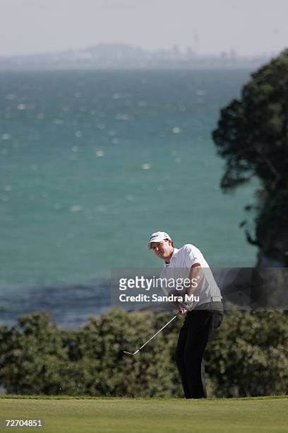 Marcus Fraser of Australia chips onto the 16th green during the final round of the New Zealand Open at Gulf Harbour Country Club on the Whangaparoa...