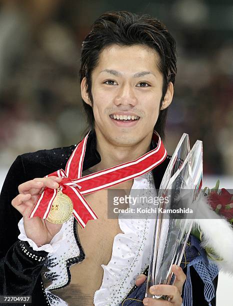 Daisuke Takahashi of Japan celebrates after winning in the Men's Free Skating Program during the ISU Grand Prix of Figure Skating-NHK Trophy at the...