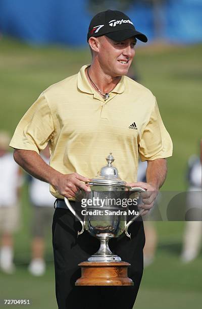 Nathan Green of Australia holds the trophy after winning the New Zealand Open at Gulf Harbour Country Club on the Whangaparoa Peninsula December 3,...
