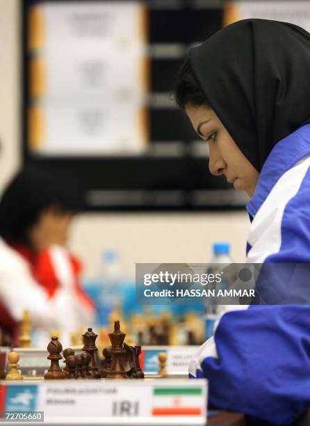 Iranian Chess player Atousa Pourkashiyan poders her move against India's Humpy Koneru at the 15th Asian Games in Doha, 0 December 2006. .AFP PHOTO /...