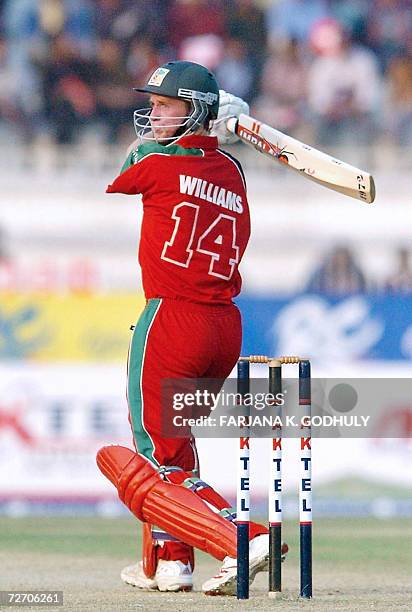 Zimbabwean cricketer Sean Williams looks on after hitting a ball to the boundary during the second One-Day International match between Bangladesh and...