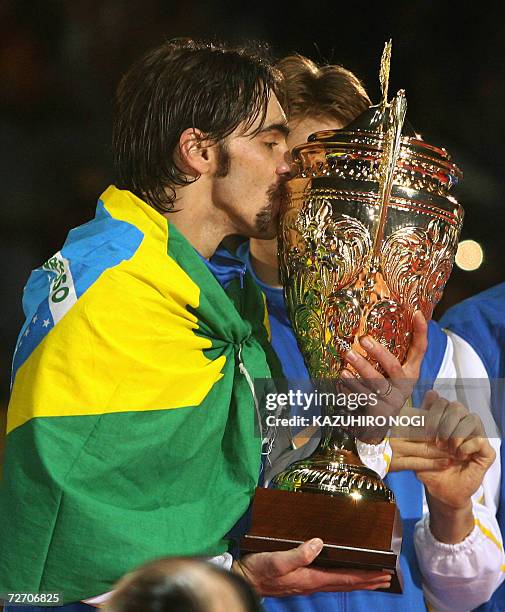 Winner Gilberto 'Giba' Godoy Filho of Brazil kisses the champion's trophy during an award ceremony after the final match against Poland at the Men's...