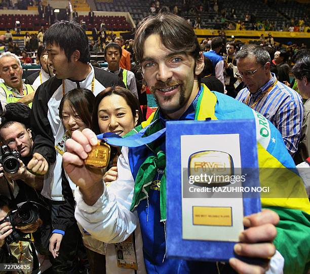 Winner Gilberto 'Giba' Godoy Filho of Brazil shows his gold medal and the winner's plate of the MVP during an awards ceremony after the final match...