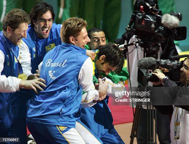 Brazil volleyball player Gilberto Godoy Filho is mobbed by teammates after being selected as the Most Valuable Player in the Men's World Volleyball...