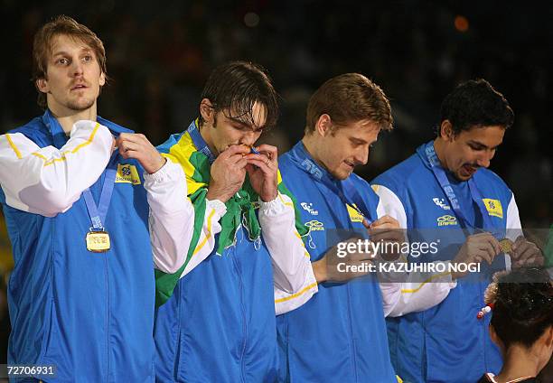 Most Valuable Players winner Gilberto 'Giba' Godoy Filho of Brazil kisses his gold medal during an awards ceremony after the final match against...