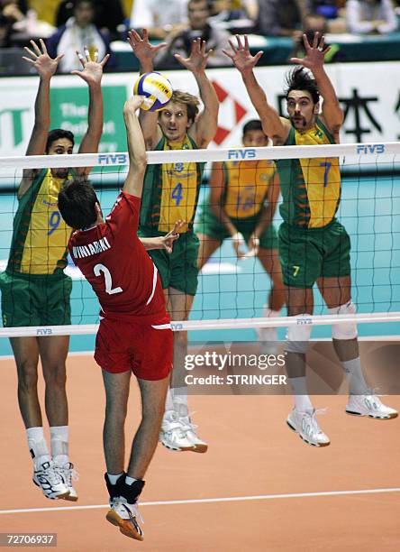 Brazil volleyball player Andre Luiz da Silva Nascimento , Andre Heller and Gilberto Godoy Filho block Poland's Michal Winiarski during the final...