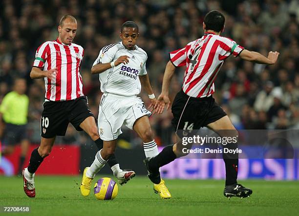 Robinho of Real Madrid tries to dribble the ball past Luis Prieto of Athletic Bilbao during their Primera Liga match at the Santiago Bernabeu stadium...