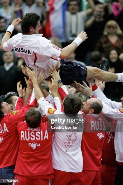 Russian team players carry Marat Safin as they celebrate his victory over Argentinian Jose Acasuso in the final match of the Davis Cup tennis...