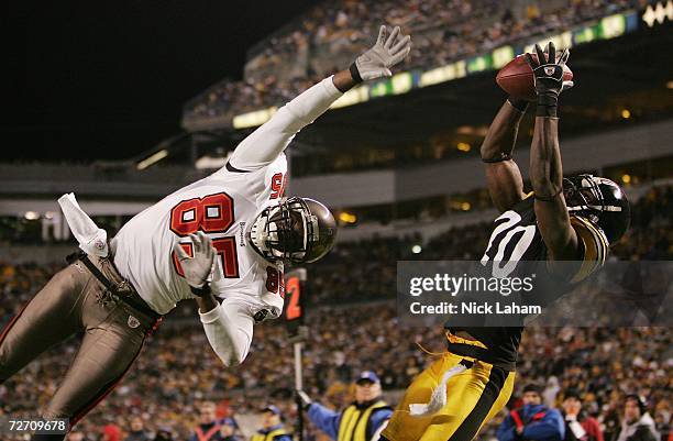 Bryant McFadden of the Pittsburgh Steelers intercepts a pass in the end zone intended for the outstretched Maurice Stovall of the Tampa Bay...