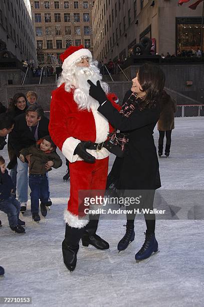 Actress Daphne Zuniga talks with Santa Claus at the Rockefeller Center Ice Rink during the ABC Family 25 Days Of Christmas Winter Wonderland Event on...