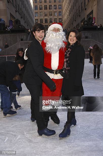 Actors Matt Dallas and Daphne Zuniga skate with Santa Claus at the Rockefeller Center Ice Rink during the ABC Family 25 Days Of Christmas Winter...