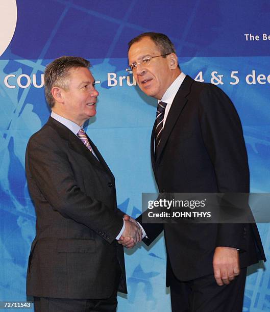 Belgium's Minister of Foreign Affairs Karel De Gucht greets his Russian counterpart Sergey Lavrov prior a working session of the Organization for...