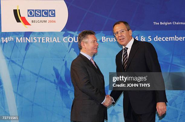 Belgium's Minister of Foreign Affairs Karel De Gucht greets his Russian counterpart Sergey Lavrov prior a working session of the Organization for...