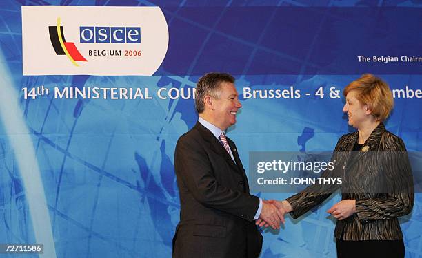Belgium's Minister of Foreign Affairs Karel De Gucht greets his Polish counterpart Anna Fotyga prior a working session of the Organization for...