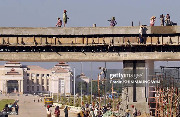 Myanmese workers construct a skyway in front of Government office in the new capital Naypyidaw 400 kilometers from Yangon, 29 November 2006. One year...