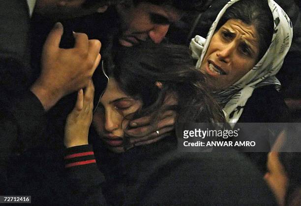 Relatives of Shiite Amal movement militant Ahmad Mahmud comfort his sister Zeinab at the al-Shahidayn Beirut morgue 04 December 2006. Mahmud, a...