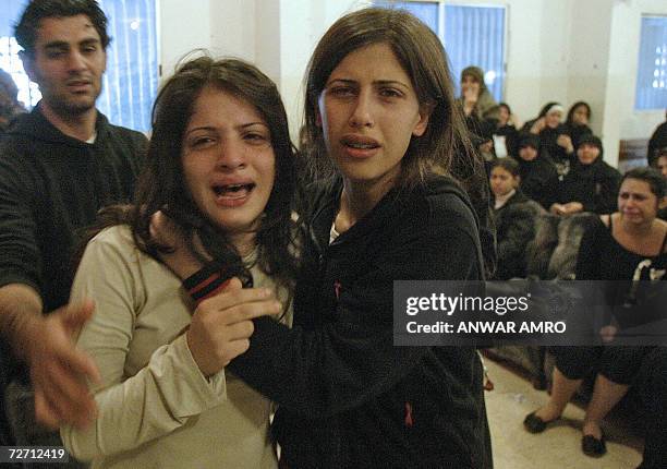 Shiite Amal movement militant Ahmad Mahmud's fiancee Sawsan , sister Zeinab and brother Hussien grieve for his loss at the al-Shahidayn Beirut morgue...