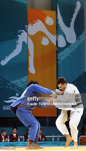 Iranian judoka Arash Miresmaeili fights with Saudi Arabian Adbulrahman Mohammed Al Hazmi during their Asian Games judo men's under 66kg preliminary...