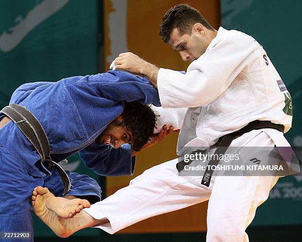 Iranian judoka Arash Miresmaeili fights with Saudi Arabian Adbulrahman Mohammed Al Hazmi during their Asian Games judo men's under 66kg preliminary...