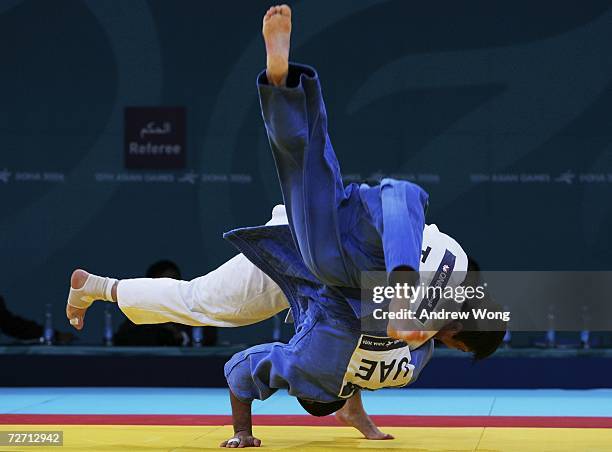 Mahdi Al-Qubaisi of the United Arab Emirates is thrown by Rasul Boqiev of Tajikistan during the Men's Judo 66kg repechage round during the 15th Asian...