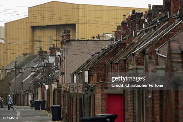 Terraced houses are dwarfed by the ship building sheds of BAE Systems the traditional home of submarine building on December 4 in Barrow in Furness,...