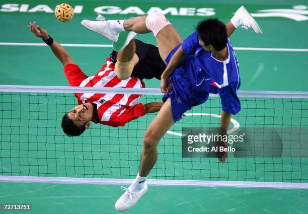 Abdul Mubin Mohd Azian of Malaysia attempts a point as Latt Zew of Myanmar defends during Sepaktakraw preliminaries at the 15th Asian Games Doha 2006...