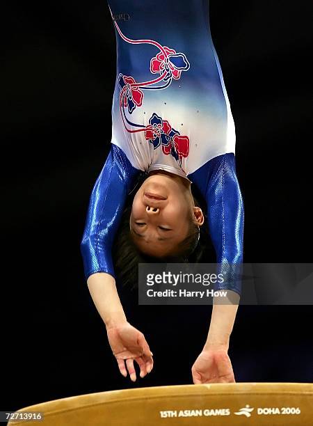 Miki Uemura of Japan competes on the vault during the Women's Individual All-Around Final at the 15th Asian Games Doha 2006 at Aspire Hall on...
