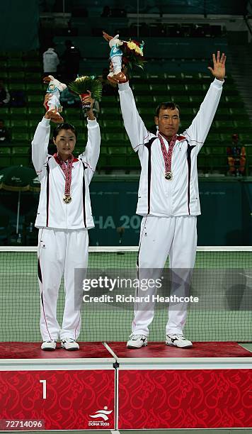 Hyu Hwan We and Ji Eun Kim of Korea celebrate with their gold medals after victory over Kim Kyung Ryun and You Young Dong of Korea in the Mixed...