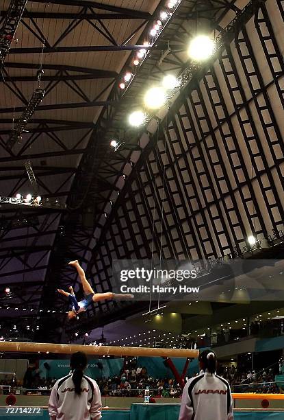 Miki Uemura of Japan is watched by her team mates as she competes on the balance beam during the Women's Individual All-Around Final at the 15th...