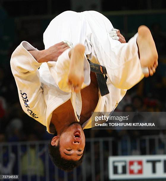 Mongolia's Tsagaanbaatar Haskhbaatar flips in the air after beating Iranian judoka Arash Miresmaeili during their Asian Games judo men's under 66kg...