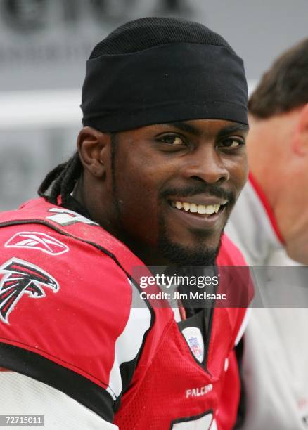 Michael Vick of the Atlanta Falcons smiles from the sidelines during a timeout of their game against the Washington Redskins on December 3, 2006 at...