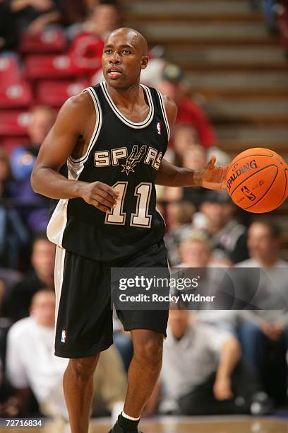 Jacque Vaughn of the San Antonio Spurs brings the ball upcourt during the game against the Sacramento Kings at Arco Arena on November 19, 2006 in...