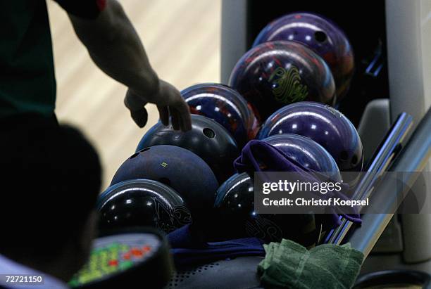 Sportsman picks up a bowling ball during the final of the Men's Trios Bowling Competition at the Qatar Bowling Centre during the 15th Asian Games...