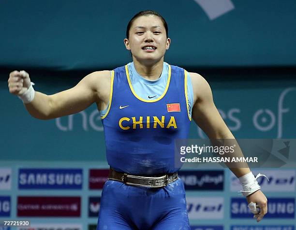 Gold winner of China Cao Lei clenches her first after winning gold in the 75kg category in women's weightlifting at the 15th Asian Games in Doha, 05...