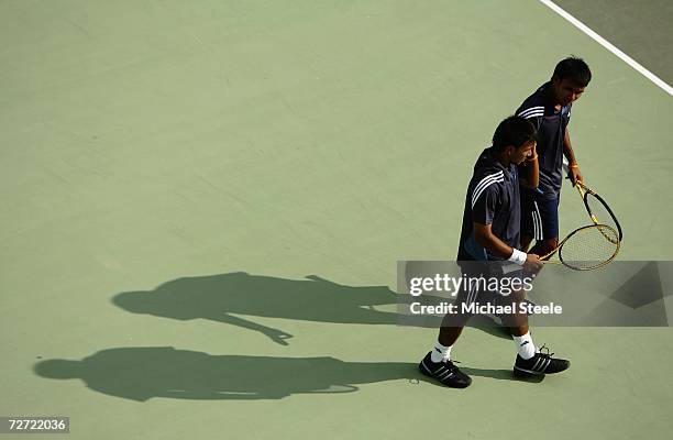 Sonchat and Sanchai Ratiwatana of Thailand discuss tactics while playing against Denis Istomin and Murad Inoyatov of Uzbekistan during the Men's Team...