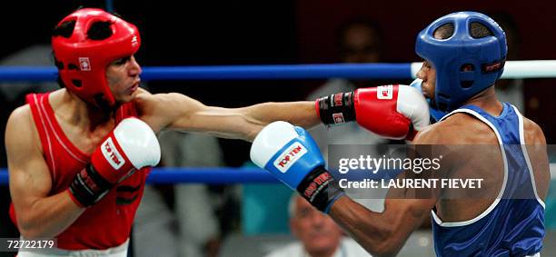 Afghan boxer Mohammad Naim Amini throws a punch to Iraqi Jabar Zuhir in their super lightwight 64kg preliminary bout during the 15th Asian Games in...