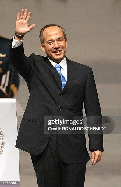 Newly inaugurated Mexican President Felipe Calderon waves to the audience 01 December, 2006 at the National Auditorium in Mexico City. Calderon...
