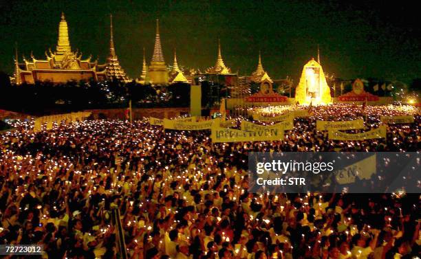 Ten thousands of Thais gather to take part in a candle-lighting ceremony of the celebrates 79th birthday of King Bhumibol Adulyadej near Grand palace...