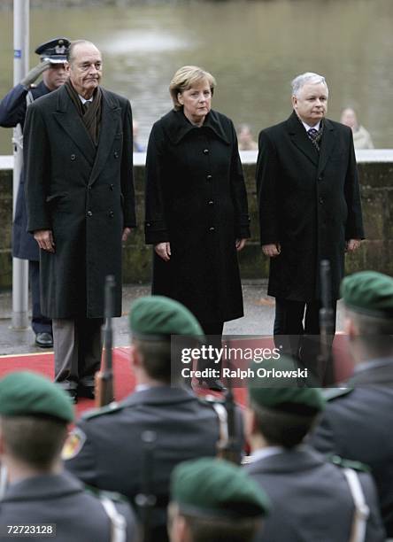 French President Jacques Chirac, German Chancellor Angela Merkel and Polish President Lech Kaczynski inspect the guard-of-honour, on December 5, 2006...